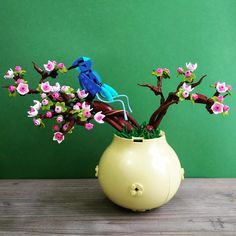 a vase filled with flowers on top of a wooden table