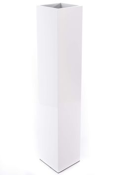 a tall white vase sitting on top of a table