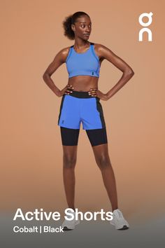 a woman in blue sports bra and black shorts with the words active shorts cobaltl black