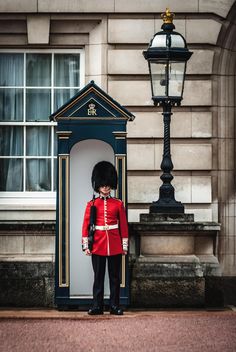 a guard standing in front of a lamp post