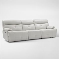 a white leather couch with two reclinings on it's back and armrests