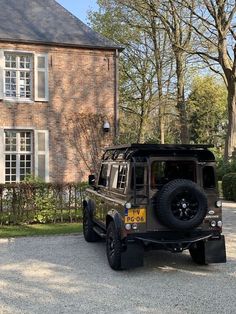 a jeep parked in front of a large brick house