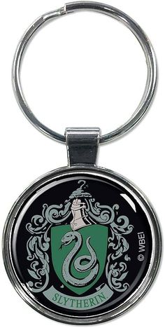 a metal keychain with a green and black sly emblem on the front side