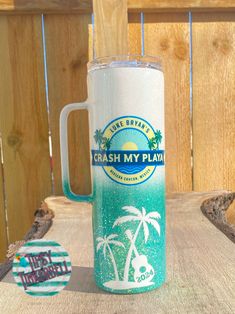 a beach themed mug sitting on top of a wooden table