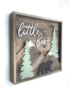 a wooden sign that says, little bear with a bear in the woods on it