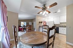 a dining room table with chairs and a ceiling fan