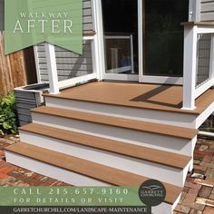 the steps are made of wood and have white railings on each side, along with brick pavers