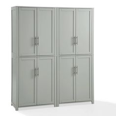 two tall gray cabinets sitting next to each other on a white surface with no one in it