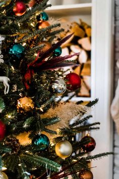 a christmas tree is decorated with colorful ornaments