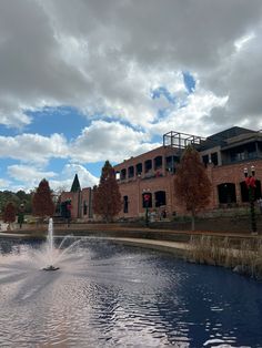 a water fountain in front of a brick building