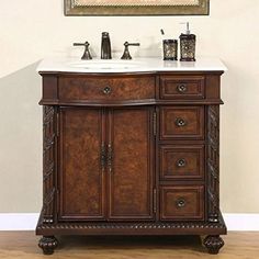 a bathroom vanity with two sinks under a painting on the wall and wooden flooring