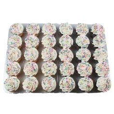 cupcakes with sprinkles are lined up on a tray