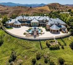 an aerial view of a large mansion in the hills