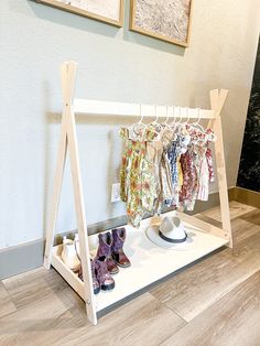 a rack with shoes and clothes hanging on it