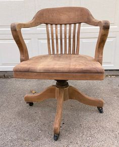 an old wooden chair sitting in front of a garage door