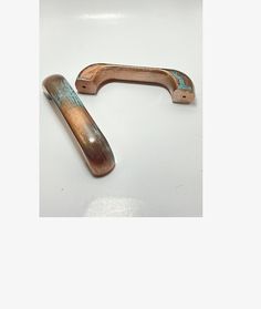 two wooden handles on a white surface