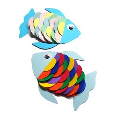 two fish made out of colored paper on top of each other