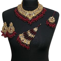 bridal jewellery set. Set includes- Necklace Earrings  Jhumar  Tikka Red Bollywood Jewelry Sets With Latkans, Gold Ruby Jewelry Sets For Wedding, Red Chandbali Bridal Necklace With Latkans, Red Chandbali Bollywood Style Jewelry, Bollywood Style Red Chandbali Jewelry, Bollywood Ruby Jewelry Sets With Stone Work, Red Bollywood Bridal Necklace With Latkans, Wedding Ruby Jewelry Sets With Stone Work, Ceremonial Red Bridal Sets With Stone Work