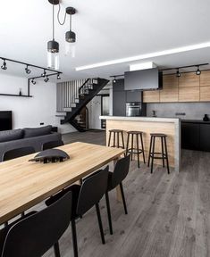 an open concept kitchen and living room with stairs leading up to the second floor area