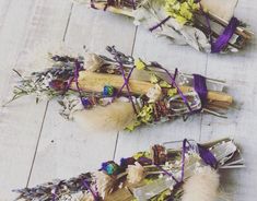 three bundles of dried flowers are on the floor next to each other and tied together