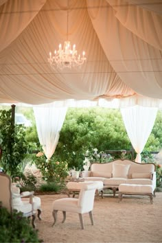 a living room filled with lots of white furniture