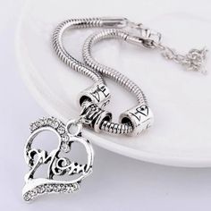 ~Silver "Mother" Open Heart Bracelet ~1" X 1 1/8" Silver Open Heart Charm ~1/4" Barrel Bail & (2) "Love" Barrel Slide Charms ~Accented With Clear Crystal Rhinestones ~7 3/4" Snake Chain W/ 2" Extension ~Secure Lobster Claw Clasp ~Silver Plated Nickel Free Alloy Metal ~Presented In Organza Gift Pouch ~Perfect For Mother's Day ~Please Bundle 2 Or More For Combined Shipping ~Same Day Shipping 1st Class 1-3 Days ~Thank You So Much For Viewing This Item ~Please Shop All My Closet & Boutique Items ~Fo Bohemian Beaded Bracelet, Purple Beaded Bracelets, Retro Heart, Mom Bracelet, Inlaid Jewelry, Bracelet Heart, Bow Bracelet, Moms Bracelet, Gift Pouch