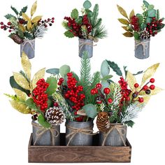 three tin cans filled with holly, berries and pine cones