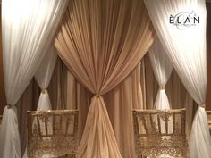 an elaborately decorated canopy bed with white drapes