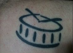 a close up of a person with a tattoo on his arm and the word drummer written in black ink