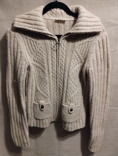 "This is a lovely Vintage Ann Taylor Loft Wool Blend Cable/Ribbed Knit Zip Front Cardigan Sz S. Made in Hong Kong of 64% wool, 22eck% acrylic, 9% nylon and 5% mohair and features a wide ribbed collar that converts into a turtleneck and side pockets. It has been gently worn and is in excellent condition. Measurements Length 22\" Shoulders 17\" Sleeves 25\" Bust 38\"" Beige Wool Cable Knit Cardigan, Fitted Wool Cable Knit Outerwear, Casual Wool Knitted Cardigan, Classic Knit Cardigan For Winter, Winter Wool Cable Knit Cardigan, Fitted Knitted Winter Outerwear, Fitted Knitted Outerwear For Winter, Fitted Knit Outerwear For Winter, Cold Weather Cable Knit Merino Wool Cardigan