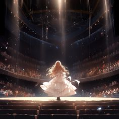 a woman standing on top of a stage in front of an auditorium filled with people