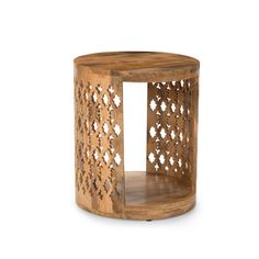 a wooden side table with an intricate cutout design on the top and bottom part