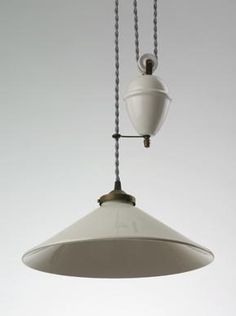 a white light hanging from a ceiling with two lights attached to it's sides