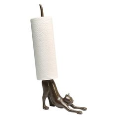 a toilet paper holder with a cat sitting on it's side and a roll of toilet paper hanging from the top