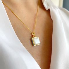 This beautiful contemporary Mother of Pearl square pendant features a turquoise enamel edging. Made from Sterling Silver with 14k gold plate, the pendant measures 12.5 x 12.5mm with an 18" gold curb chain. It's a stunning piece of jewellery on its own, but layered with other pieces it gives a more dramatic evening look, a lovely gift or something special for yourself  The matching earrings measure 7 x 7mm.  Mother of Pearl gemstone has been used to promote healing and wellness. One of the most s Gold Plate Necklace, Square Pendant Necklace, Necklace Layering, Plate Necklace, Enamel Necklaces, Square Pendant, Pearl Gemstone, Layering Necklace, Gold Plated Necklace