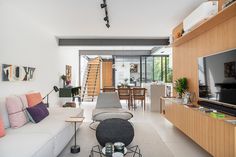 a living room filled with furniture and a flat screen tv