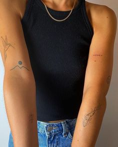 two people with tattoos on their arms