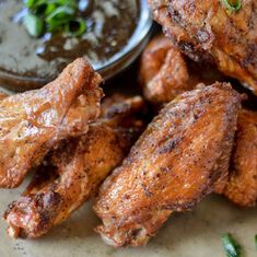 chicken wings with dipping sauce on the side