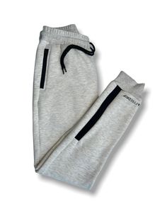 Our men's grey fleece tracksuit joggers come with black stripes and a zip and button front and 2 handy front pockets for storage. The soft feel of the fabric and new strip design gives this tracksuit a new look and feel. Perfect for those weekend walks around the city on those cooler summer days. Pair these warm comfortable joggers with our Men's Fleece Hoodie to complete the look. Gray Fleece Joggers For Streetwear, Fleece Sportswear Joggers, Luxury Cotton Joggers For Men, Sportswear Fleece Joggers With Moisture-wicking, Mens Fleece Hoodie, Strip Design, 4-way Stretch Sportswear Joggers With Side Pockets, Jogger Pants Casual, Casual Joggers