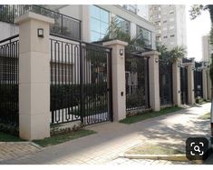 a car is parked in front of a building with iron fences on the side walk