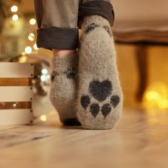 Person's feet in home interior wearing gray pants and gray low-cut goat wool warm socks with a black paw-print design. Camping Socks, Paws Socks, Pretty Socks, Handmade Socks, Force Of Nature, Apex Predator, House Features, Sock Knitting Patterns, Knitted Socks