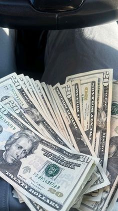 a bunch of money sitting in the back seat of a car