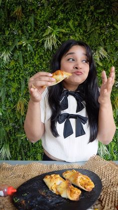 a woman sitting at a table with food in front of her and looking up to the sky