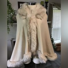 This Beautiful Cape Is Made Of A Soft Knit Fabric Bordered With A Faux Fur. Has A Hook And Eye Closure. Fits Up To A Large.Beautiful Cream Color Elegant One-size Beige Outerwear, Chic One-size Winter Outerwear, Cozy One Size Cream Outerwear, Cloak With Fur, Wanted Aesthetic, Fur Wedding Cape, Cream Fur Coat, Fur Cloak, Winter Cloak