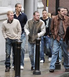 a group of men walking down the street