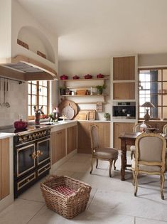 a kitchen filled with lots of wooden cabinets and furniture next to a stove top oven