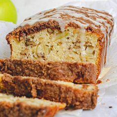 sliced loaf of cake sitting next to an apple