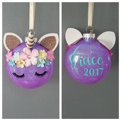 two christmas ornaments with unicorn ears and flowers on them, one has the word fierce written on it