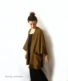 Handmade khaki green boho kimono robe with pockets. Our kimono robe comes in a wide and loose style, one-size-fits all. This is one of our favourite kimono jackets as it is made with a slightly heavier khaki green cotton viscose fabric, giving it a more oversized shirt/ cardigan feel when worn. This is a beautiful simple fabric which creates strong shadows in movement due to its very slight sheen that we are happy shows in the photographs too. Finished with wide arm quarter length sleeves and a Fall Season Relaxed Fit Wrap Kimono, Fall Kimono With Relaxed Fit And Kimono Sleeves, Brown Kimono With Kimono Sleeves For Fall, Long Fall Kimono With Relaxed Fit, Long Relaxed Fit Kimono For Fall, Long Relaxed Fit Fall Kimono, Fall Long Relaxed Fit Kimono, Casual Beige Kimono For Fall, Oversized Kimono With Kimono Sleeves For Winter