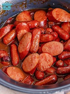 cooked sausages are in a pot with water